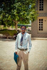 Confident young man holding a file outdoors, embracing urban business style.