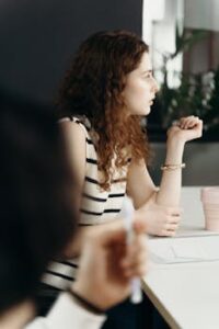 Focused businesswoman attentively listening during a meeting in a modern office.