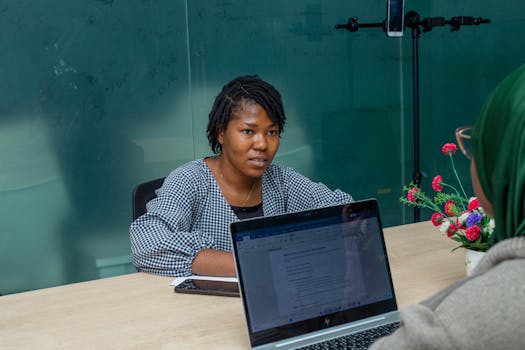 Professional business meeting in a Lagos office with diverse team members collaborating.