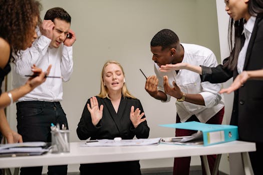 Diverse employees engaged in a heated discussion at a workplace meeting, showcasing stress and tension.